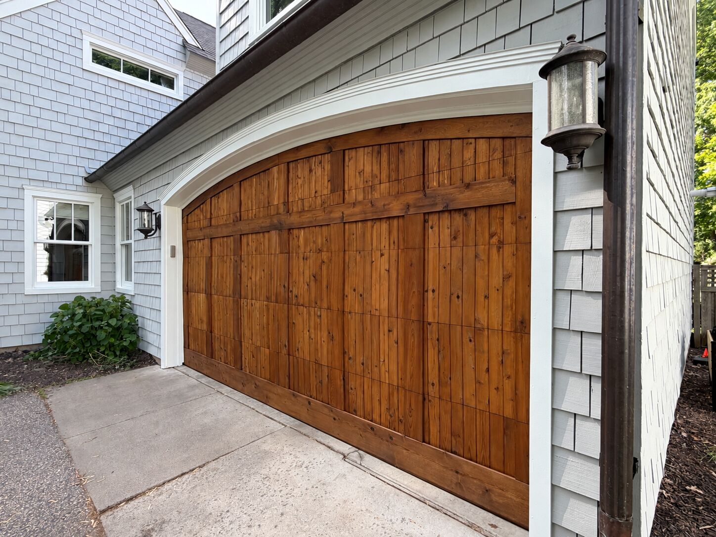 Refinished wooden garage door by Maki Painting & Maintenance